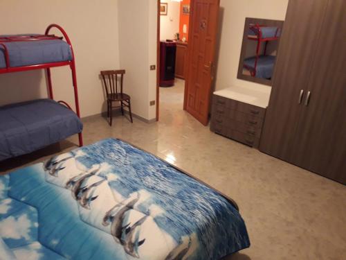 a bedroom with two bunk beds and a mirror at DESULO casa vacanze in Desulo