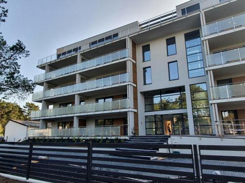 an apartment building with stairs in front of it at APARTAMENT NIEBIESKA FALA in Rowy