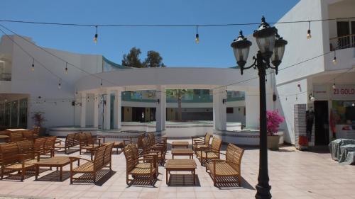 a patio with chairs and tables and a street light at Sharm Hills Resort in Sharm El Sheikh