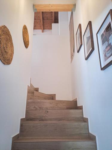 a stairway with pictures on the wall and a stair case at Paragem dos Pacatos - Odeceixe in Odeceixe