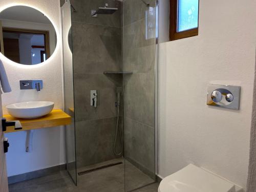 a bathroom with a shower and a sink at Tomsan Suites & Villas Akyaka in Akyaka