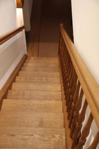 a stairway with wooden railings in a building at Hotel Hofwirt Neubeuern in Neubeuern