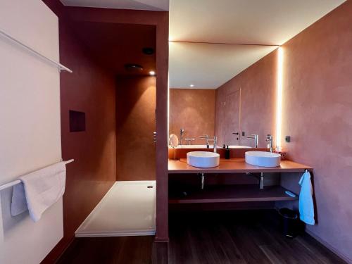 a bathroom with two sinks and a large mirror at Ferias - cosy house in Bruges