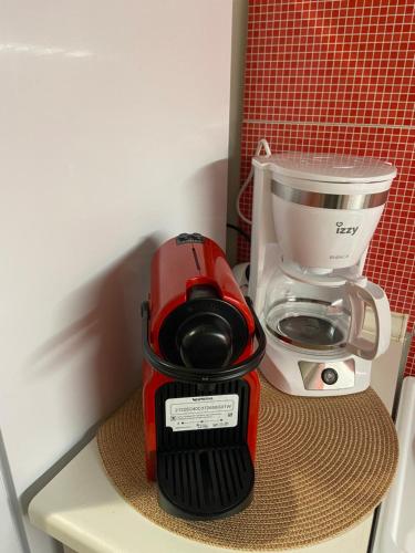 a red coffee maker sitting on top of a counter at Zoi's central home in Volos