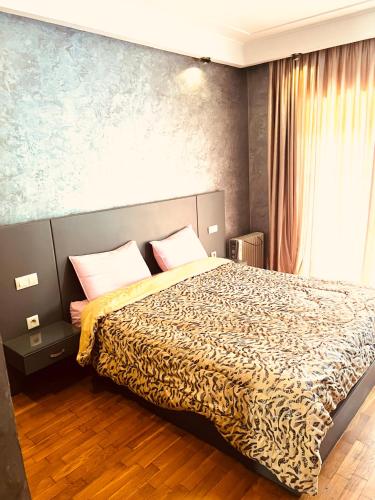 a bedroom with a bed in a room with a window at Corniche apartments in Casablanca