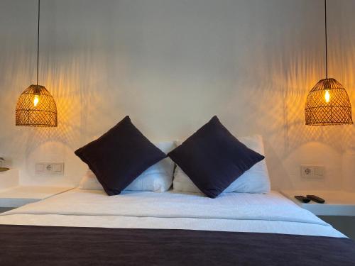 a bedroom with a bed with two pillows on it at Tomsan Suites & Villas Akyaka in Akyaka