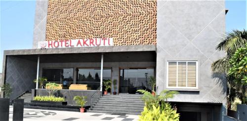 a hotel kiryu building with stairs in front of it at Hotel Akruti, Nanded in Nānded