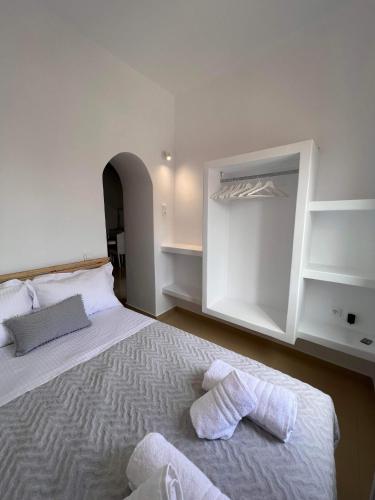 a bedroom with a bed with two towels on it at Marianna's Studio in Tinos