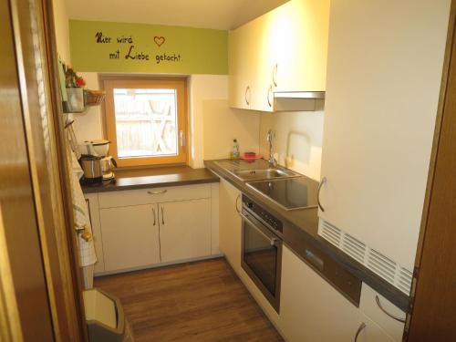 a small kitchen with a sink and a stove at Apartment Hof am Schönbach - STA160 by Interhome in Sankt Jakob