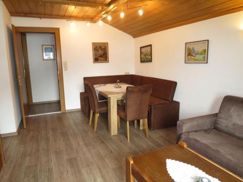 a living room with a table and a couch at Apartment Hof am Schönbach-2 by Interhome in Sankt Jakob