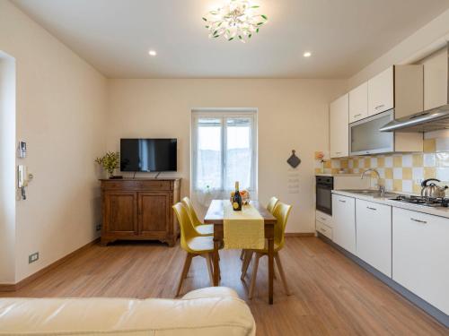 a kitchen with a table and chairs in a room at Apartment Coty - IMP522 by Interhome in Imperia