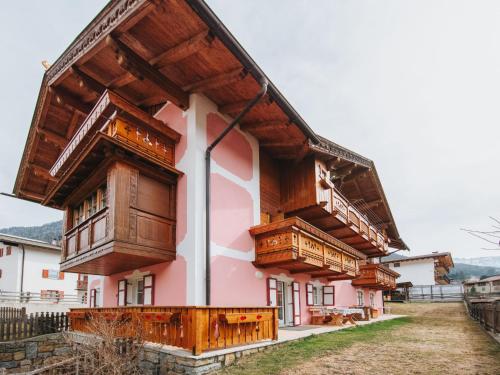 a house with wooden balconies on the side of it at Apartment Brunel-1 by Interhome in Pozza di Fassa