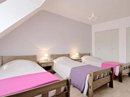 three beds in a room with pink and white sheets at Holiday Home Le Clos Er Bert by Interhome in Sarzeau