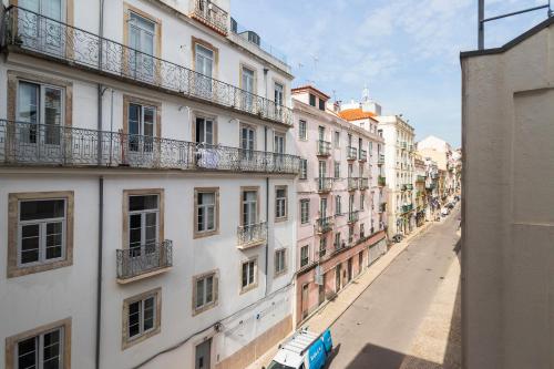 an empty street in a city with buildings at Glória 10 in Lisbon