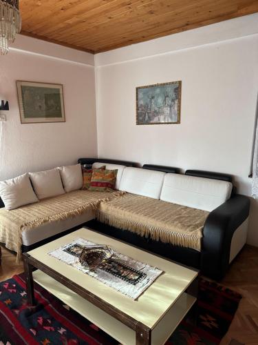 a living room with a couch and a table at Vila Popovski in Ljubaništa
