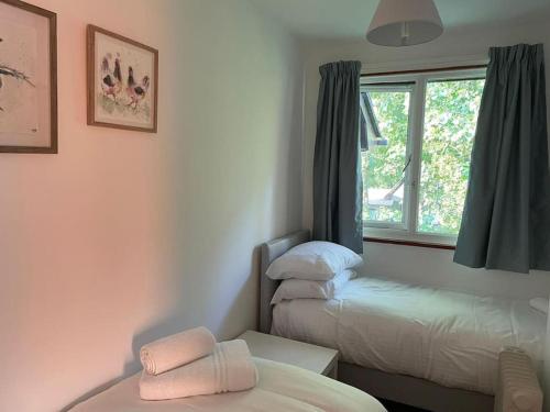 a room with two beds and a window at 37 Strawberry Hill, Hayle in Hayle
