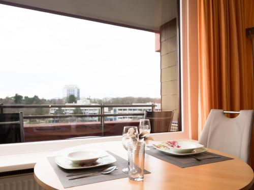 a dining table with a view of a window at Apartment B806 by Interhome in Lahnstein