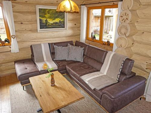 a living room with a couch and a table at Chalet Chalet Karin by Interhome in Innsbruck