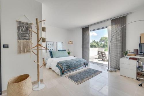 a bedroom with a bed and a desk and a window at VAR ZENITUDE in Lorgues