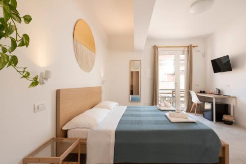 a bedroom with a large bed and a desk at Onda del Conero in Numana