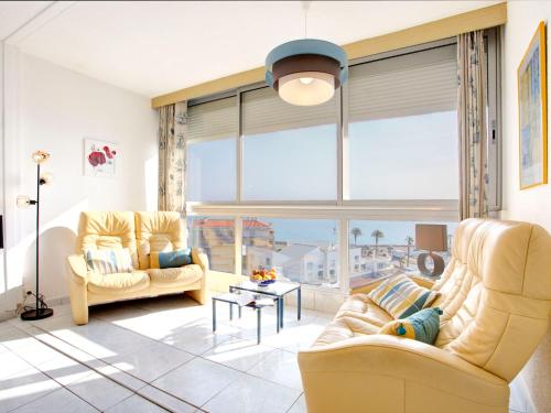 - un salon avec deux chaises jaunes et une grande fenêtre dans l'établissement Apartment Ibis-2 by Interhome, à Saint-Cyprien