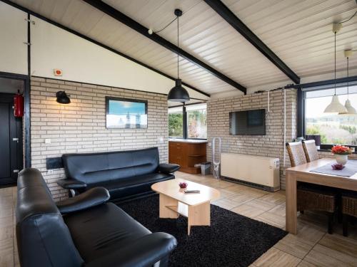 a living room with a couch and a table at Holiday Home Waldferienpark Gerolstein-11 by Interhome in Gerolstein