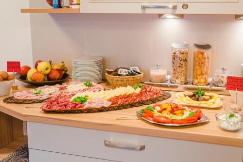 a buffet with many different types of food on a counter at Garni Schmiedhof in Naturno