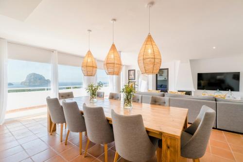 uma sala de jantar com mesa e cadeiras em Villa Serretes em Cala Vadella
