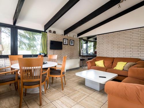 a living room with a couch and a table at Holiday Home Waldferienpark Gerolstein-16 by Interhome in Gerolstein