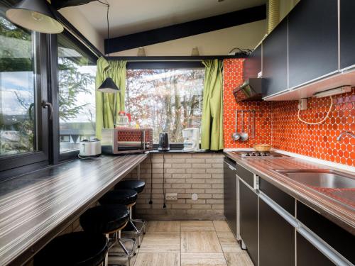 a kitchen with a counter with a sink and a window at Holiday Home Waldferienpark Gerolstein-16 by Interhome in Gerolstein