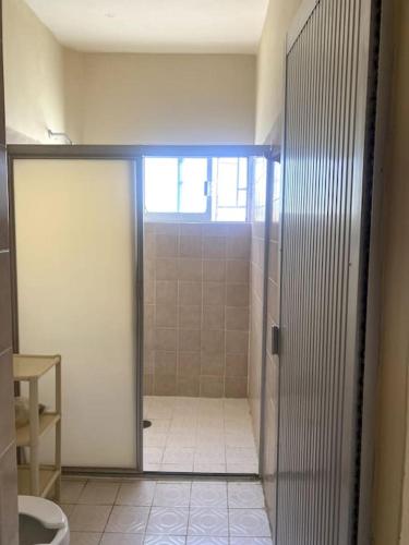 a bathroom with a shower stall and a toilet at Bungalow at the beach all services in Rincon de Guayabitos