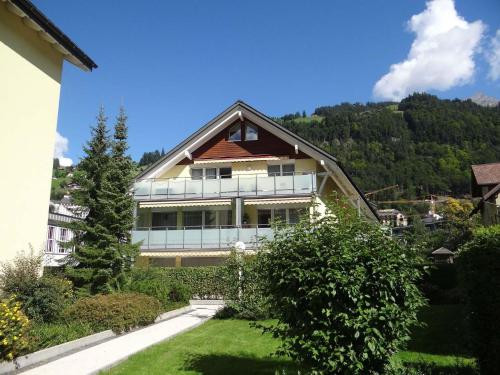 a large house with a hill in the background at Apartment Bellevue-Park B 138 by Interhome in Engelberg