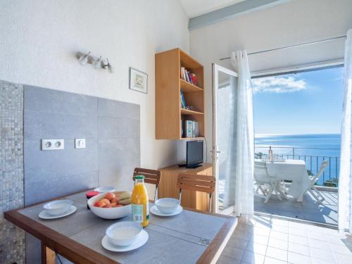a kitchen with a table with a bowl of fruit on it at Apartment Le Paradou-4 by Interhome in Rayol-Canadel-sur-Mer