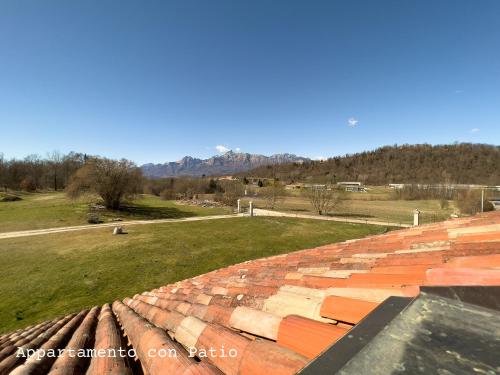 a view from the roof of a building with a field at Fienile Chiaramada in Belluno