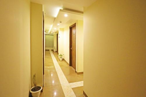 a hallway with a toilet and a potted plant at Mayda Inn- A Boutique Hotel in New Delhi