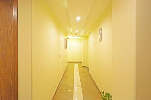 a hallway with a long corridor with yellow walls at Mayda Inn- A Boutique Hotel in New Delhi