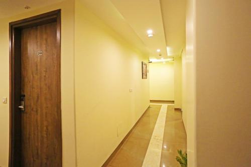 an empty hallway with a wooden door and a hallway at Mayda Inn- A Boutique Hotel in New Delhi
