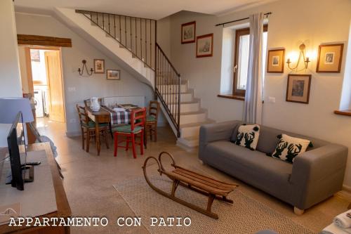 a living room with a couch and a table at Fienile Chiaramada in Belluno