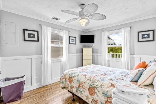 a bedroom with a bed and a ceiling fan at Sunny Side Up in Sunset Beach