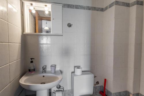 a small bathroom with a sink and a toilet at Elia mini suites 7 in Larisa
