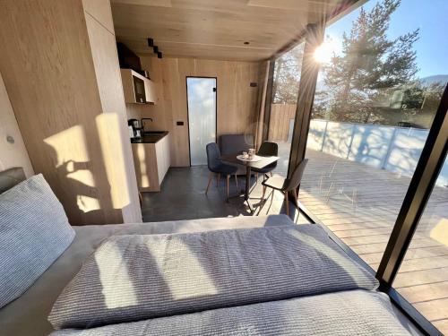 a bedroom with a bed and a balcony with a table at Chalet PANORAMA Lodge by Interhome in Imst