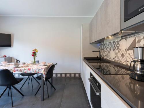 a small kitchen with a table and chairs in a room at Apartment Ormeasco by Interhome in Imperia
