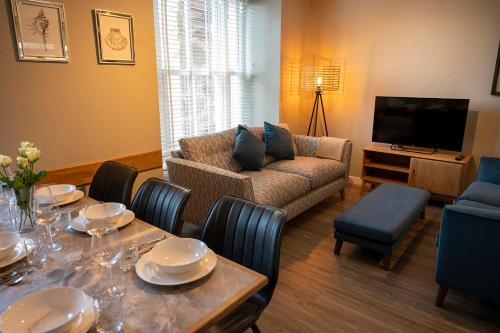 a living room with a table and a couch at The Fanny Talbot in Barmouth