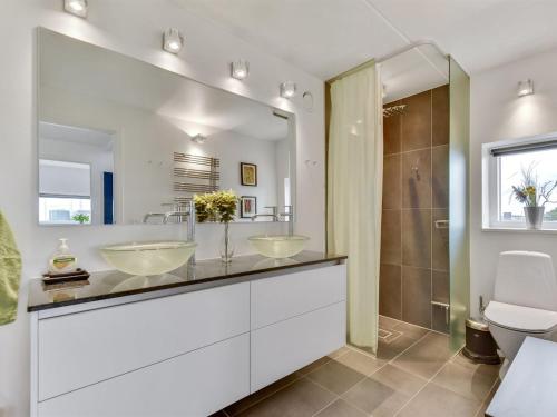 a bathroom with two sinks and a shower at Holiday Home Leto - 2km from the sea by Interhome in Havneby