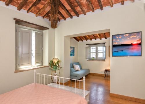 a bedroom with a bed and a couch in a room at Casale1918 in Pietrasanta