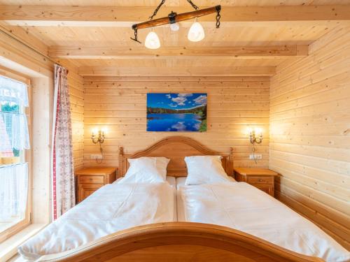 a bedroom with two beds in a wooden room at Holiday Home Chalet Toni mit Sauna by Interhome in Spiegelau