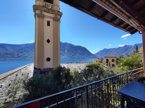 a lighthouse on a balcony with a view of a lake at Holiday Home Tower Bell House by Interhome in Isola Comacina