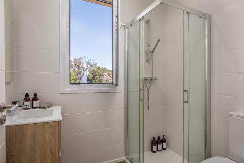 a bathroom with a shower and a sink at Casa Ciudamar Costa Brava - BY EMERALD STAY in Begur