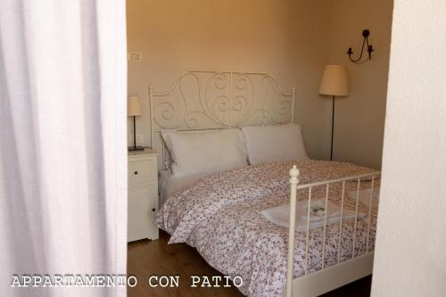 a bedroom with a bed with a white bed frame at Fienile Chiaramada in Belluno