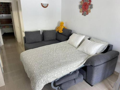 a couch and a table in a living room at Puskas Apartman in Costa de Antigua
